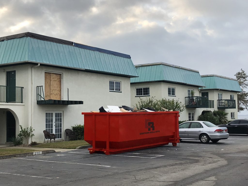 over fill line dumpster outside of apartment complex