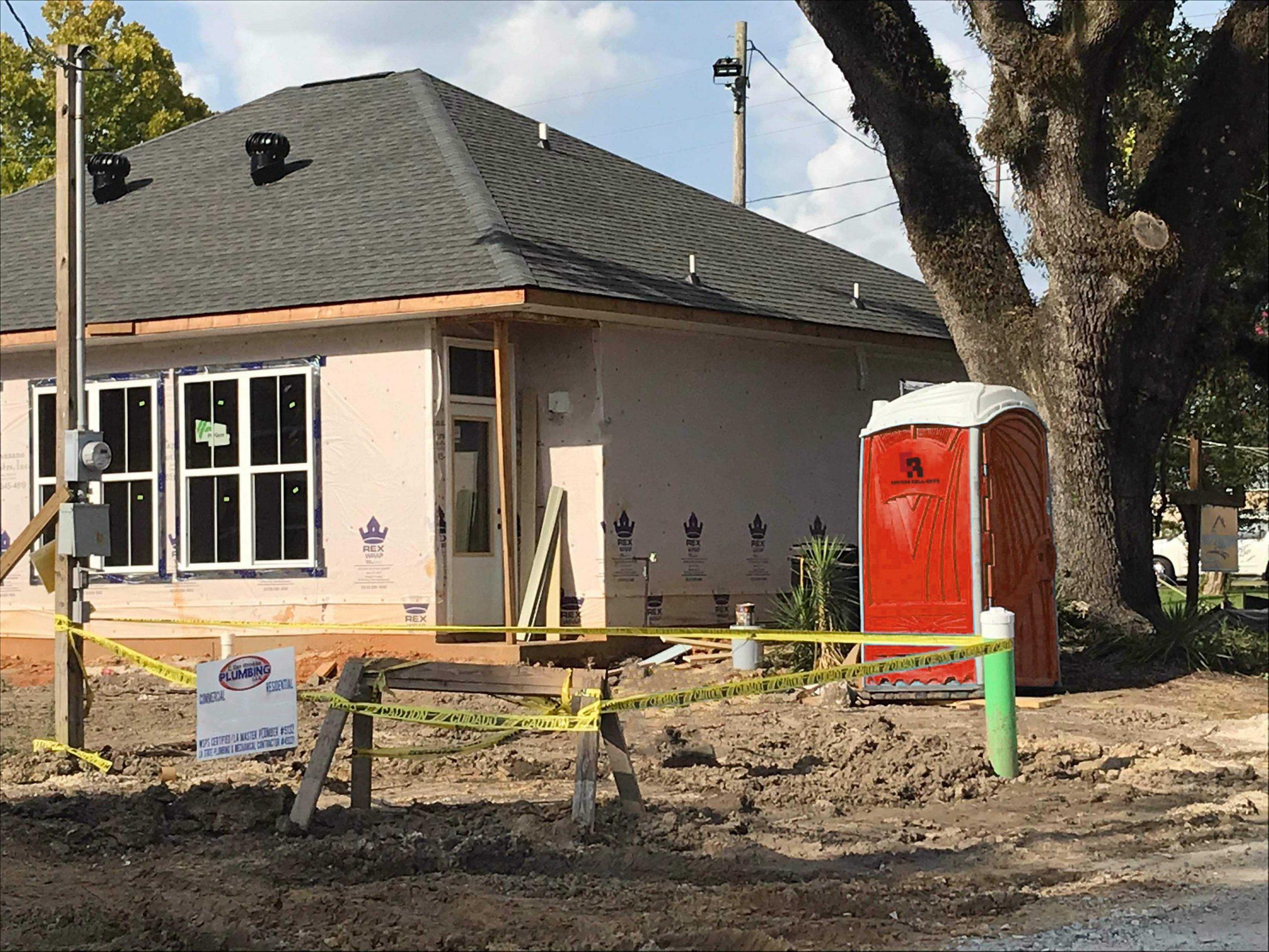 portable toilet next to new home construction